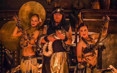 Medieval dinner show with snake dancers holding pythons.