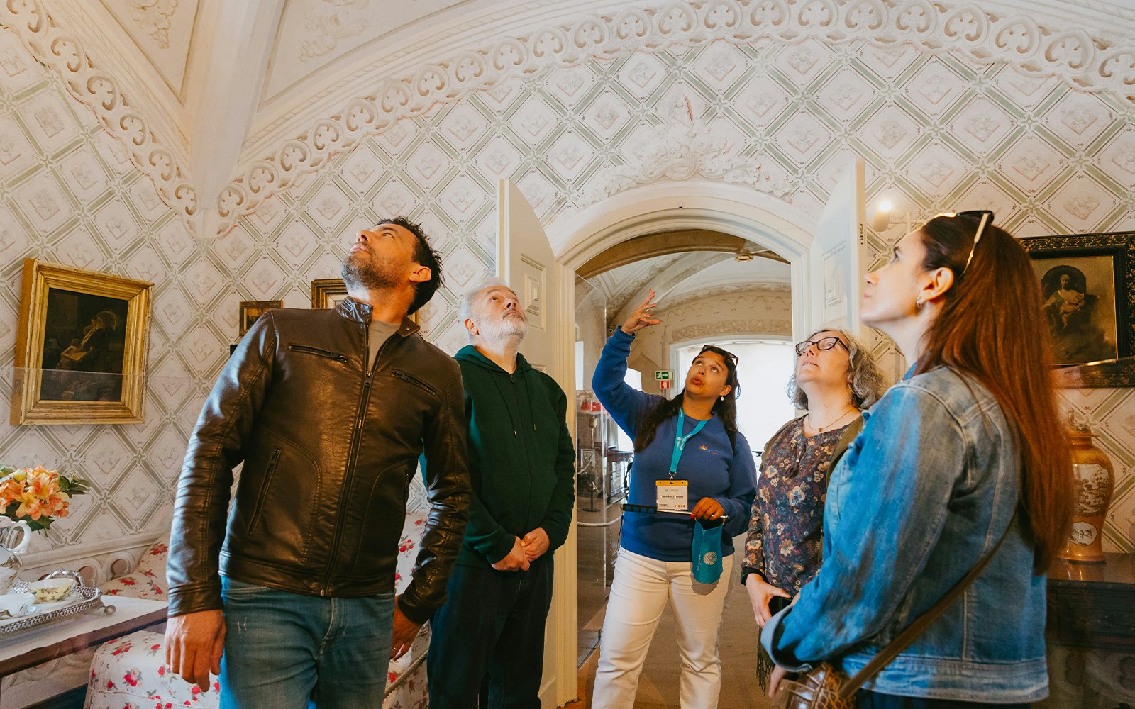 Guide explaining the history of the National Palace of Sintra to a group of tourists in Lisbon, Portugal.