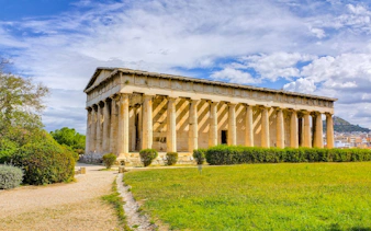 Temple of Hephaestus in the Ancient Agora of Athens, Greece, surrounded by greenery.