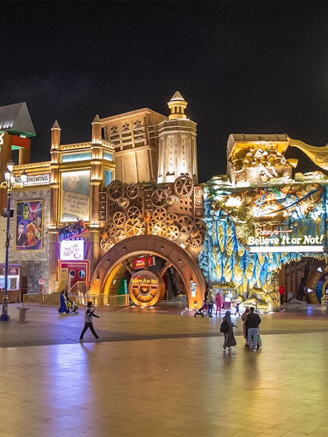Global Village Dubai at night with Korea Pavilion and Ripley's Believe It or Not attractions.