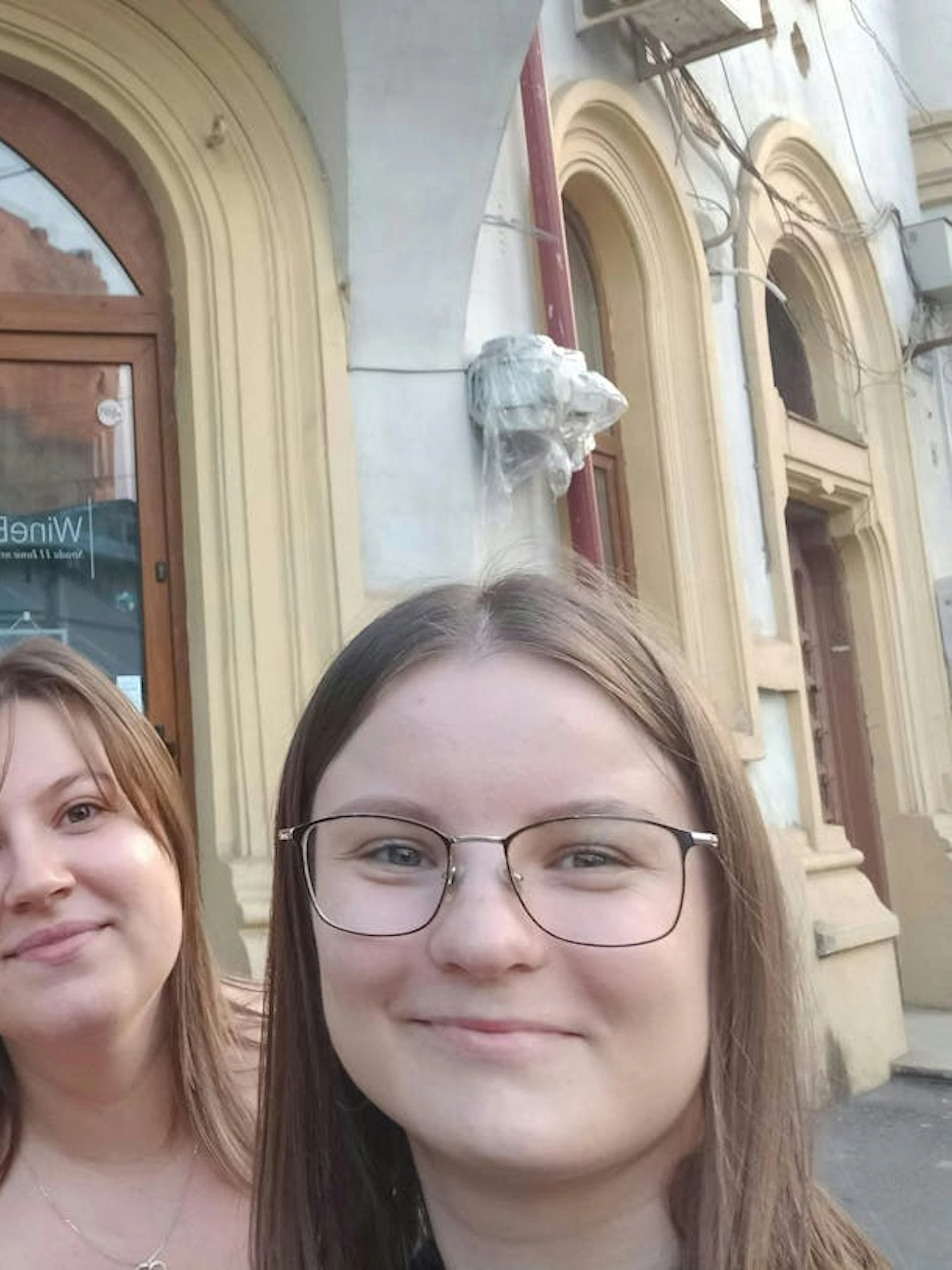 Group taking a selfie in front of a historic building in Bucharest during Dracula's Secret Journal tour.