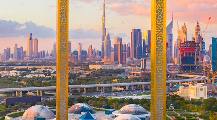 Dubai Frame with city skyline in the background, showcasing iconic architecture.