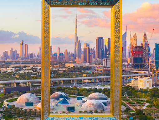 Dubai Frame with city skyline in the background, showcasing iconic architecture.