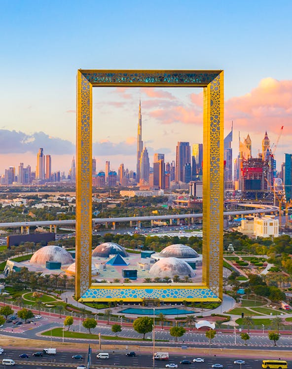 Dubai Frame with city skyline in the background, showcasing iconic architecture.