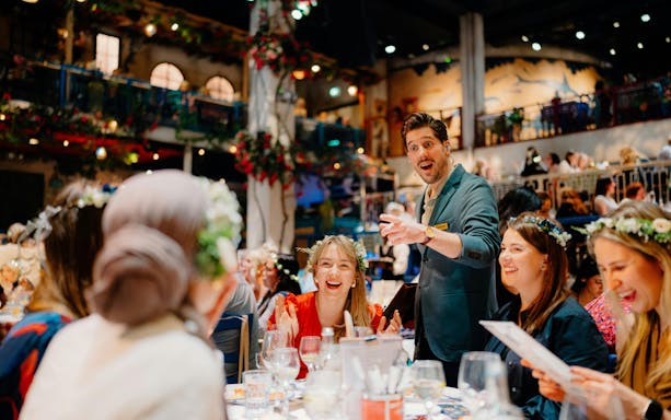 Guests enjoying dinner and entertainment at Mamma Mia! The Party event.
