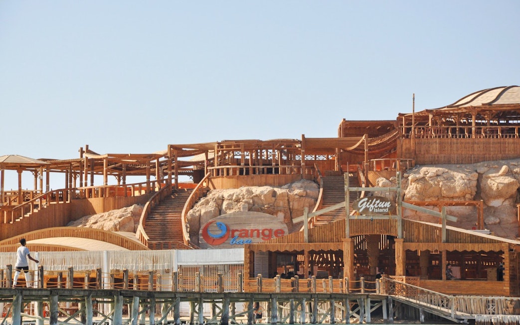 Giftun Island wooden structure with stairs and Orange Bar sign, part of Giftun 3 Islands Tour.