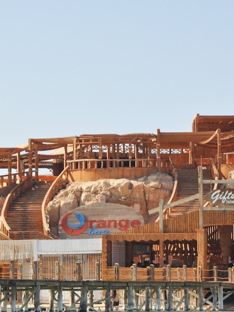 Giftun Island wooden structure with stairs and Orange Bar sign, part of Giftun 3 Islands Tour.