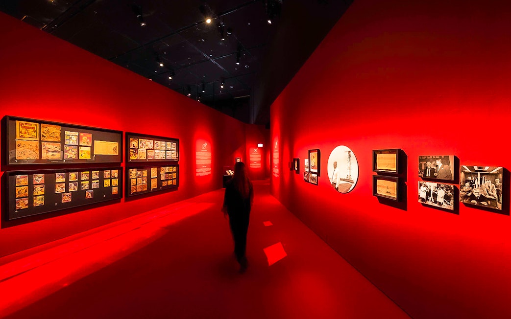 Exhibition hall with red walls displaying art at Singapore Future World Exhibition.