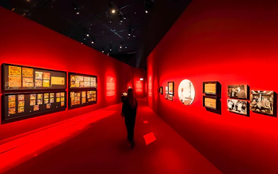 Exhibition hall with red walls displaying art at Singapore Future World Exhibition.