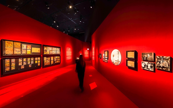 Exhibition hall with red walls displaying art at Singapore Future World Exhibition.