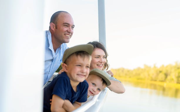 Family enjoying a boat tour on the Finniss River near Darwin.