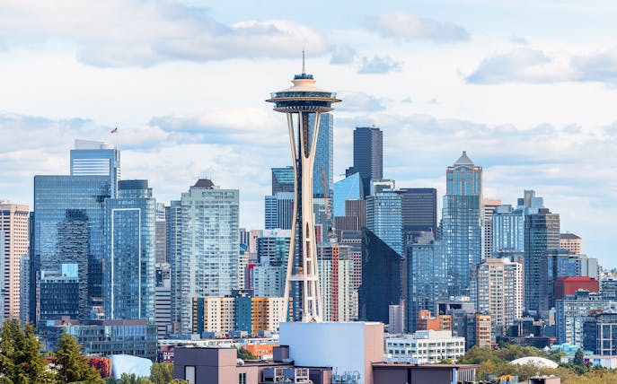 Seattle skyline featuring the Space Needle with surrounding skyscrapers.