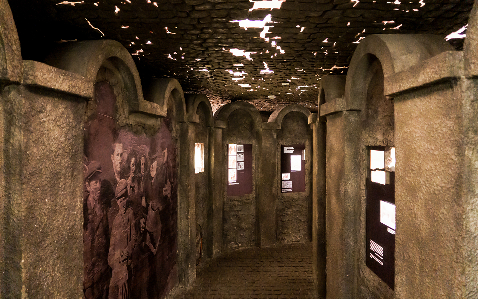 Exhibit hallway with historical photos and displays inside Oskar Schindler's Factory Museum.