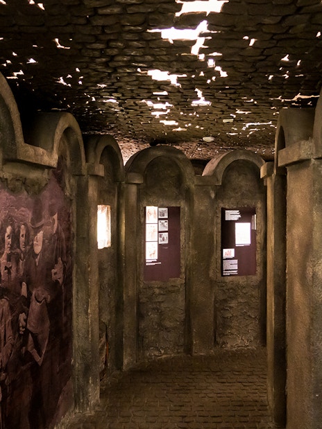 Exhibit hallway with historical photos and displays inside Oskar Schindler's Factory Museum.