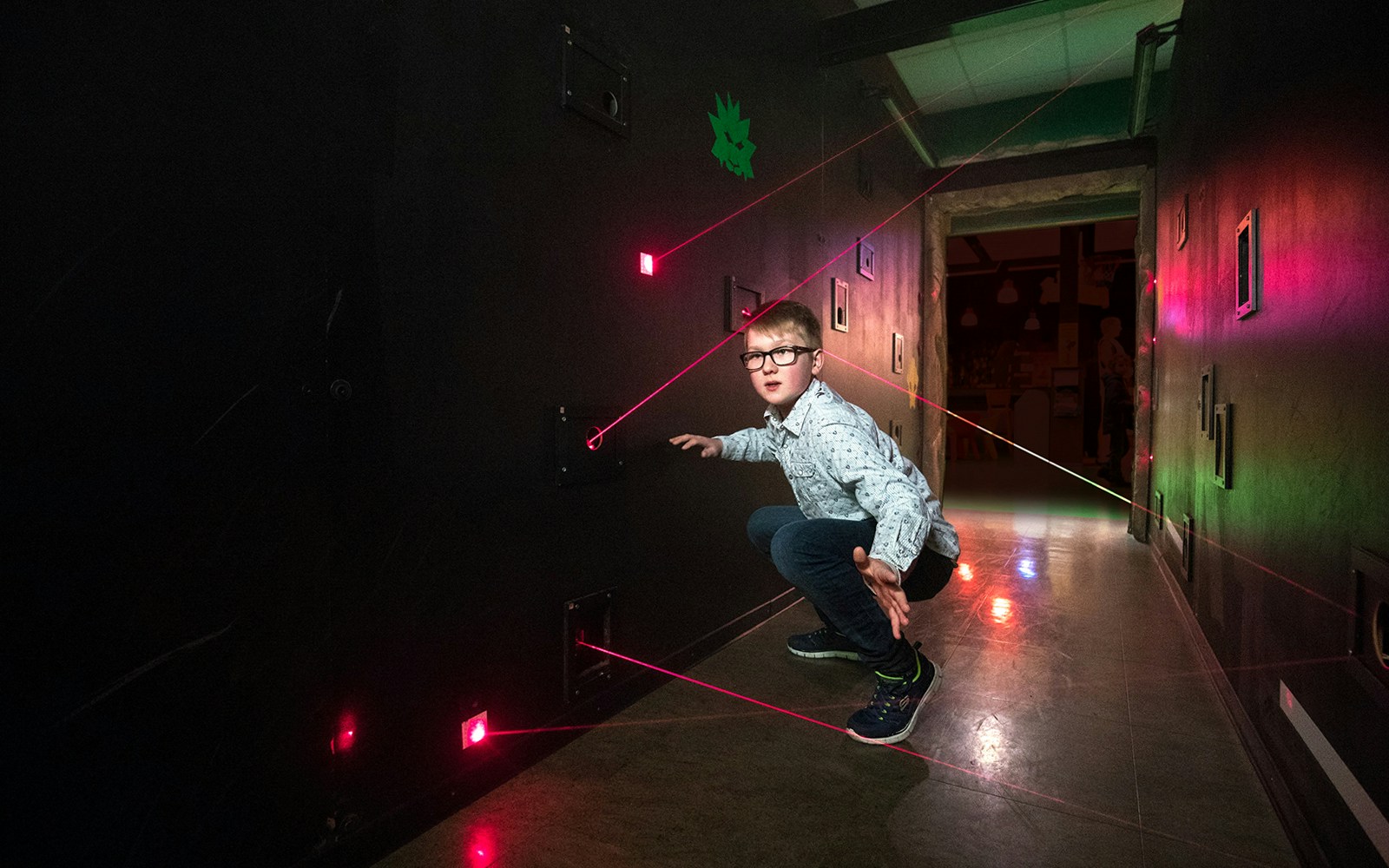 Child navigating laser maze at LEGO Ninjago, LEGOLAND Discovery Centre Berlin.