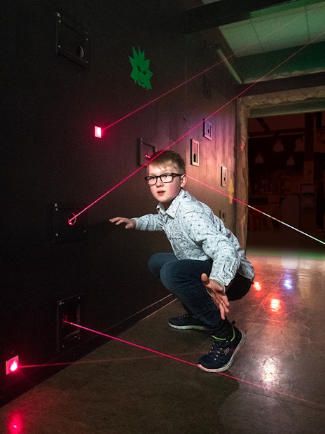 Child navigating laser maze at LEGO Ninjago, LEGOLAND Discovery Centre Berlin.