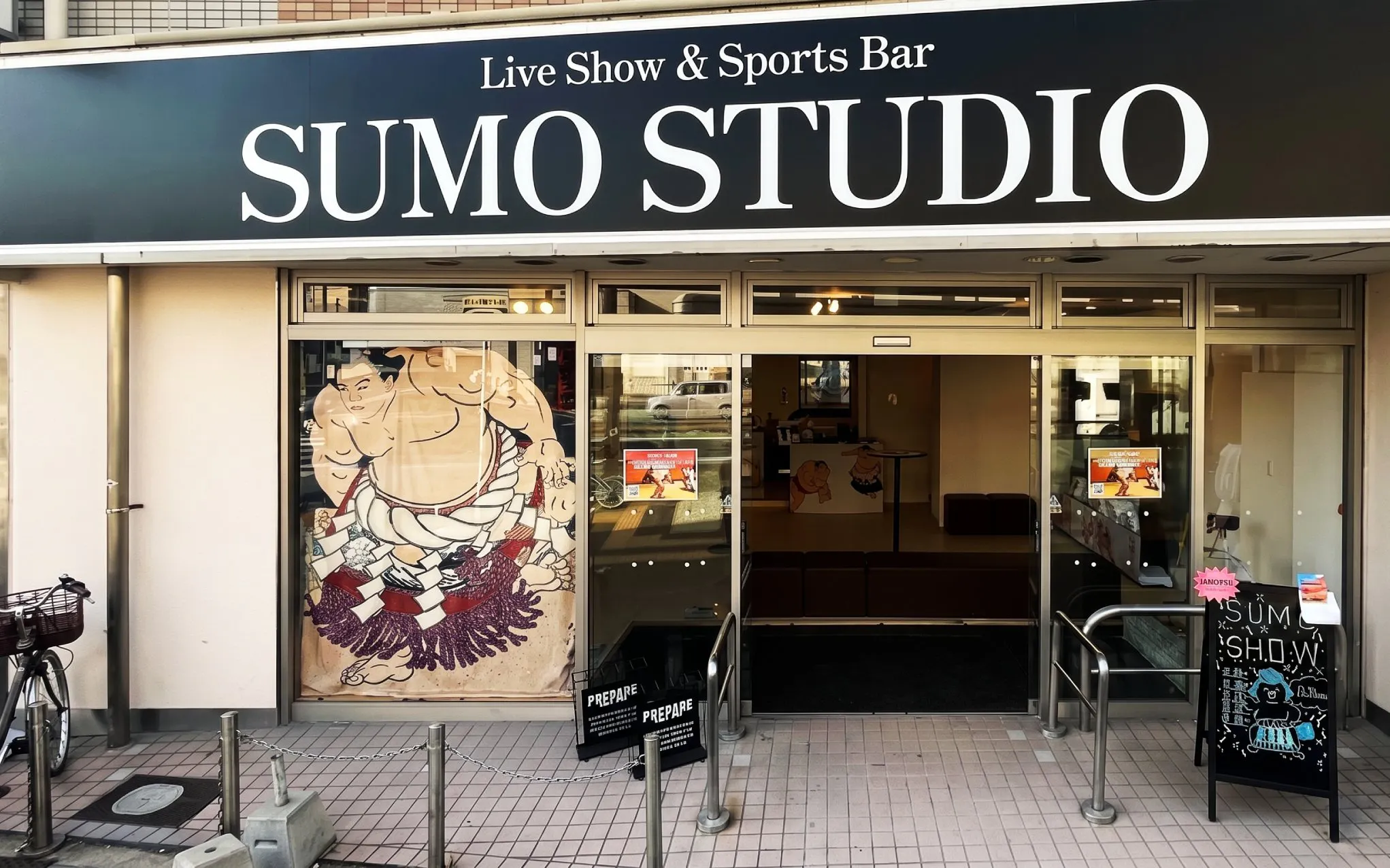 Sumo Studio entrance in Osaka offering live sumo shows and audience challenges.