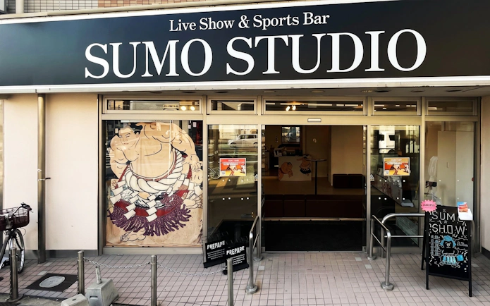 Sumo Studio entrance in Osaka offering live sumo shows and audience challenges.