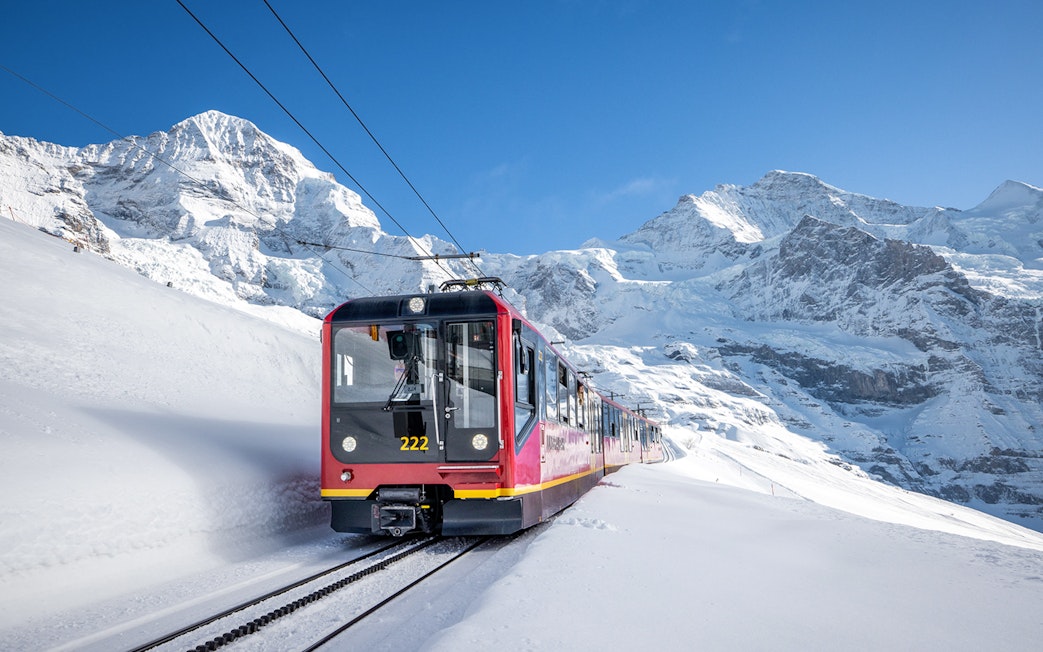 Train ascending snowy mountains to Jungfraujoch, Switzerland.
