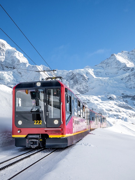 Train ascending snowy mountains to Jungfraujoch, Switzerland.