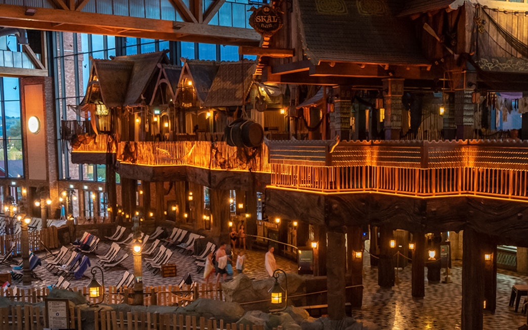 Indoor view of Rulantica water park with themed decor and lounge chairs.