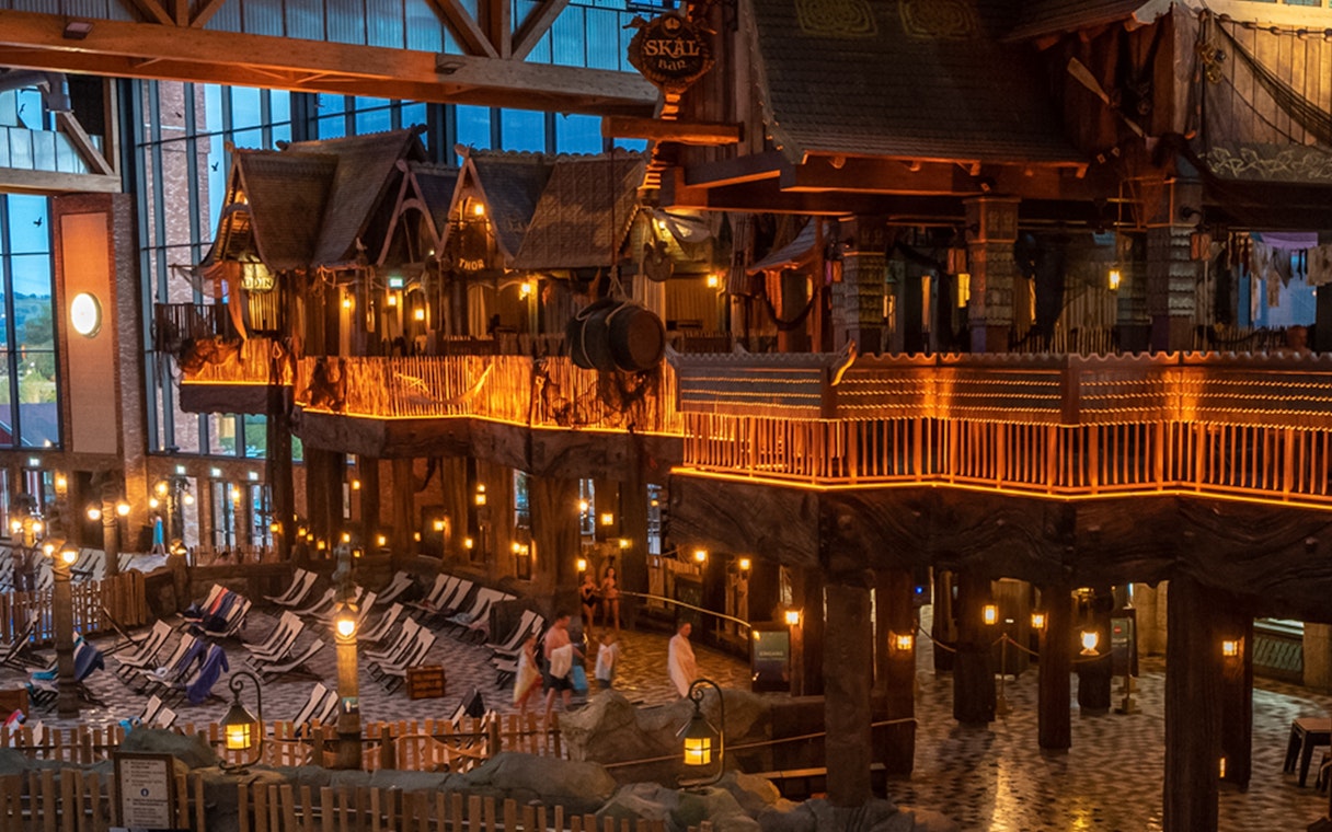 Indoor view of Rulantica water park with themed decor and lounge chairs.