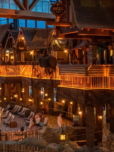 Indoor view of Rulantica water park with themed decor and lounge chairs.