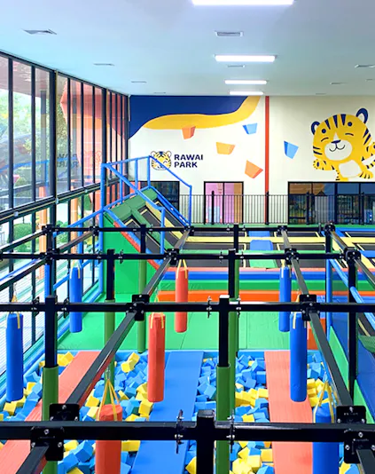 Indoor playground with obstacle course at Rawai Park, featuring colorful foam blocks and climbing structures.