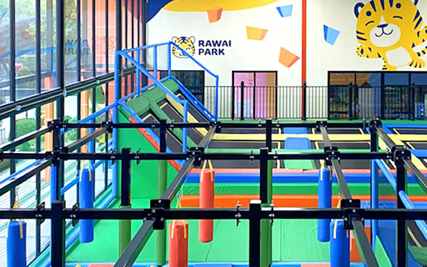 Indoor playground with obstacle course at Rawai Park, featuring colorful foam blocks and climbing structures.