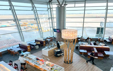 Rose Business Lounge at Tan Son Nhat Airport, Terminal 2, with buffet and seating area.