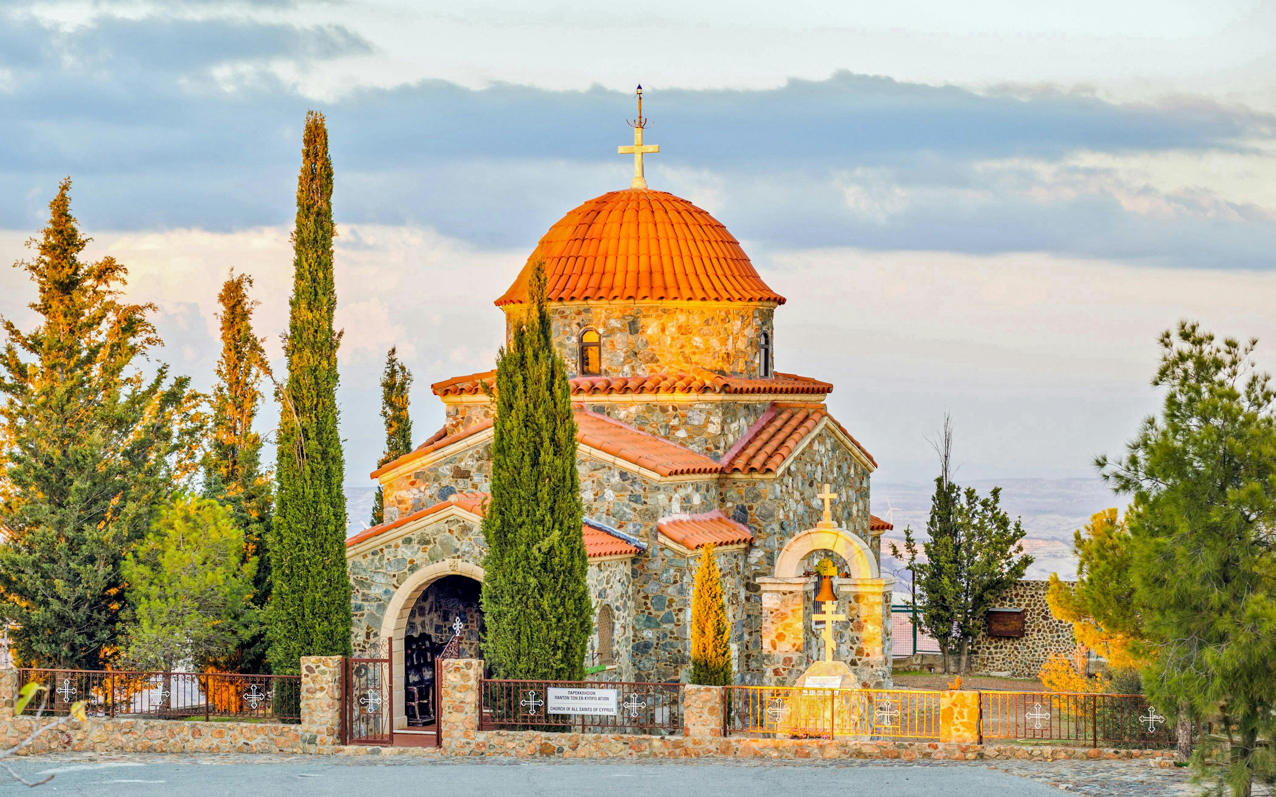 Church of All Saints with stone facade and red dome near Stavrovouni Monastery, Larnaka District, Cyprus.