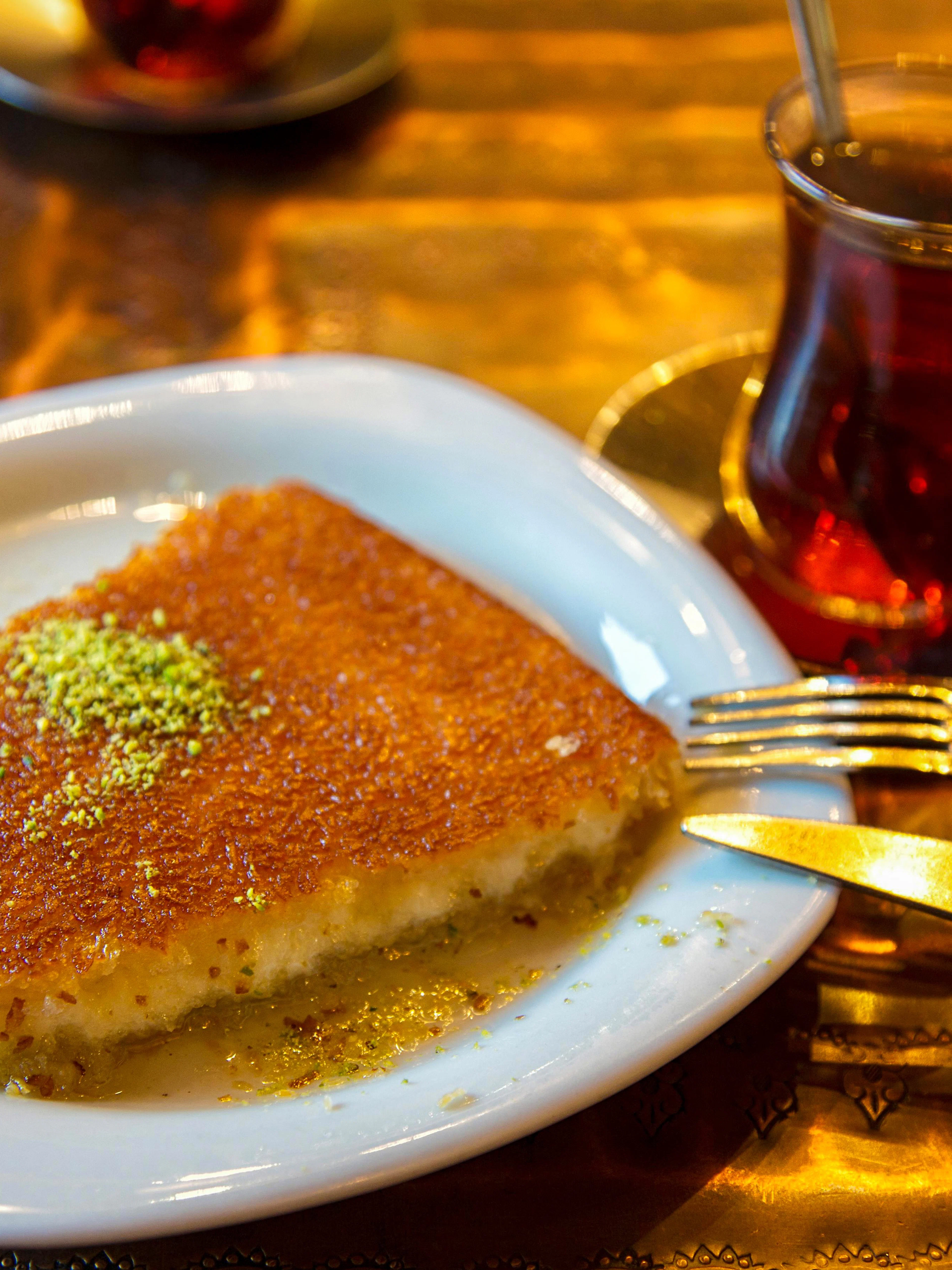 Kunefe with pistachio powder and tea on Istanbul street food tour.