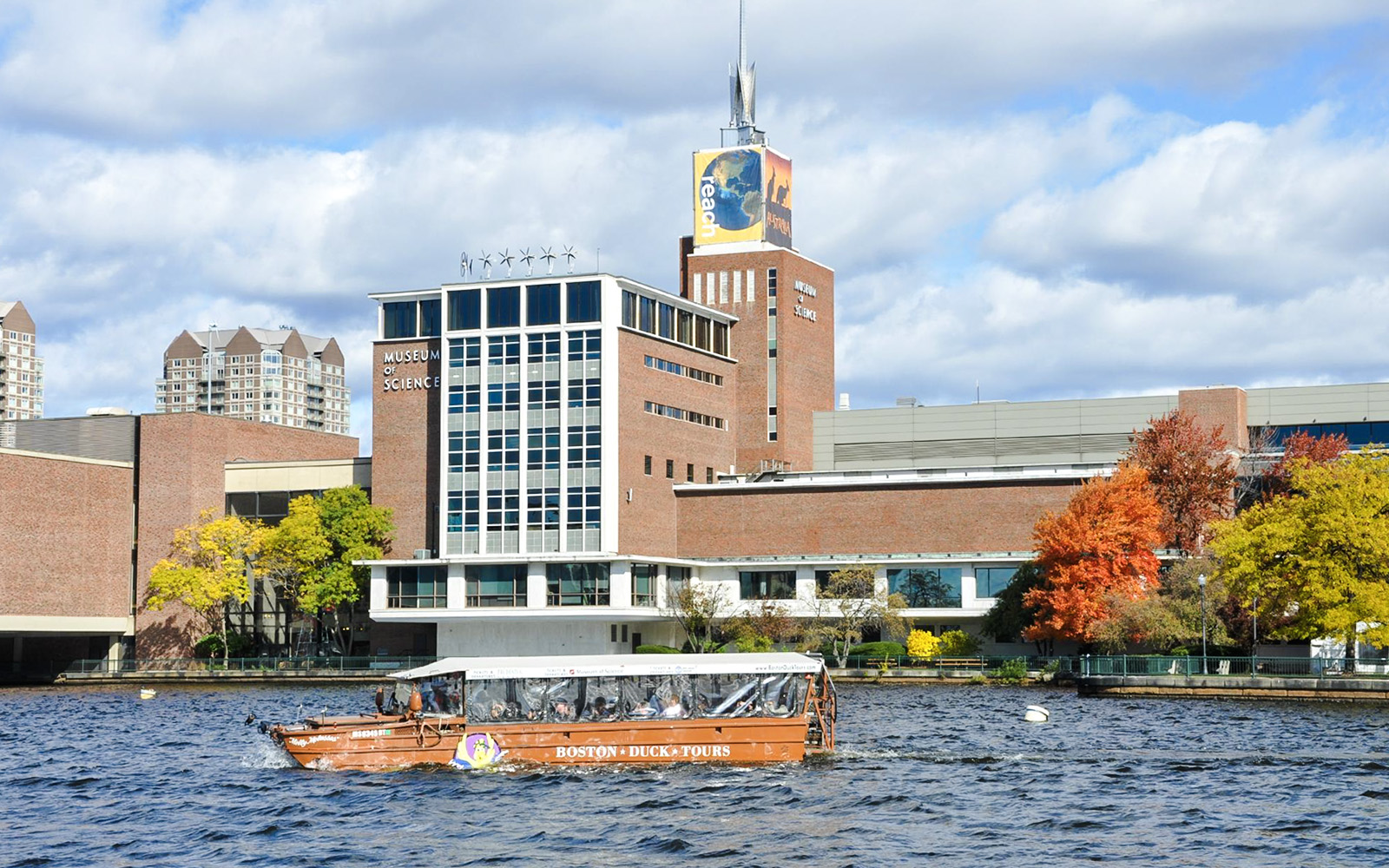 Boston Duck Tours boat cruising past the Museum of Science on the Charles River.
