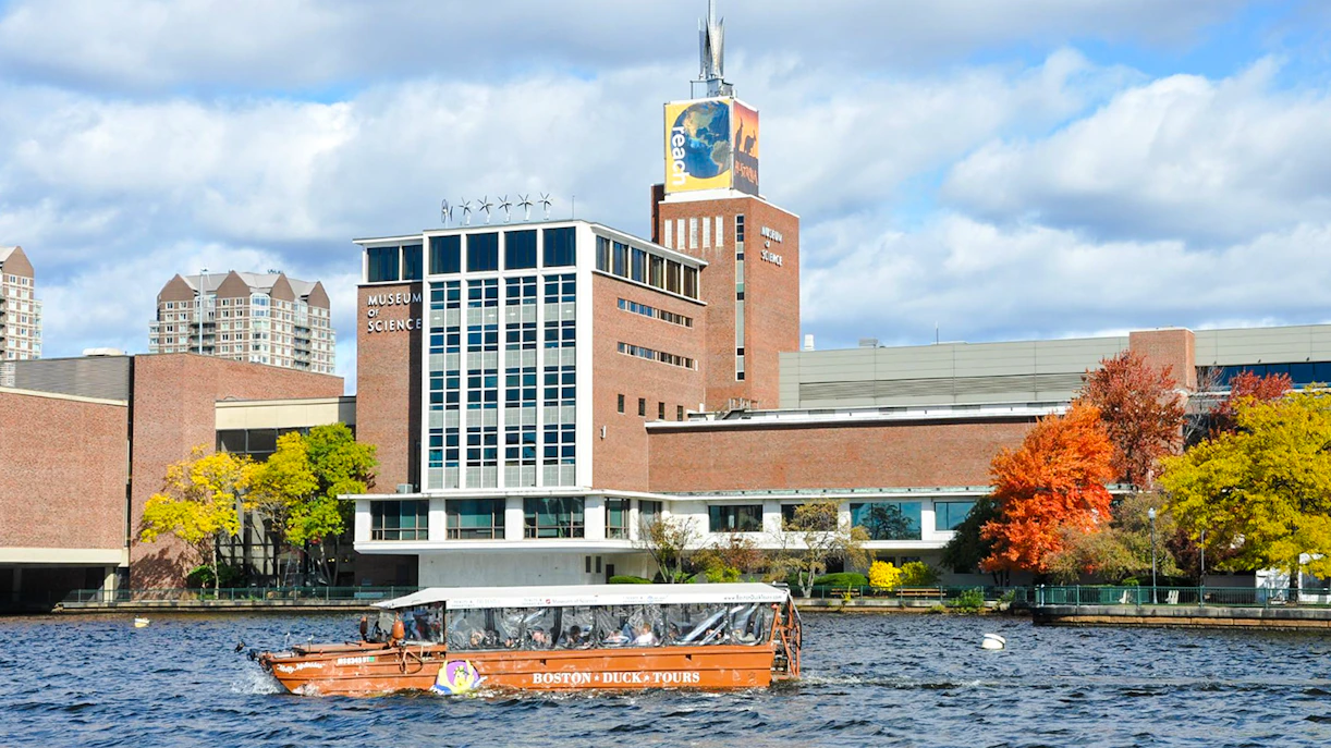 Boston Duck Tours boat cruising past the Museum of Science on the Charles River.