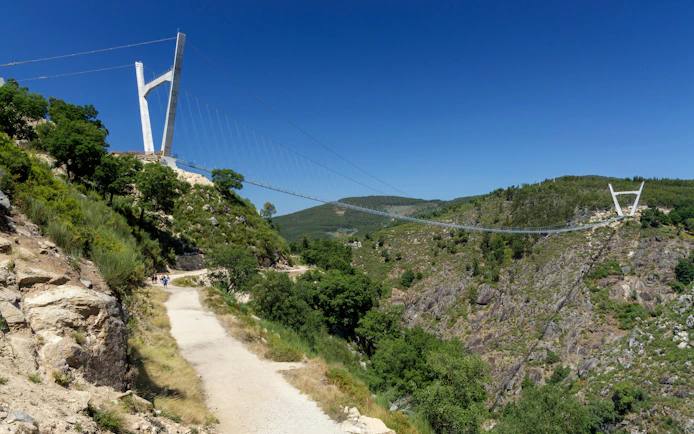 Arouca 516 suspension bridge spanning a lush valley with Paiva walkways below.