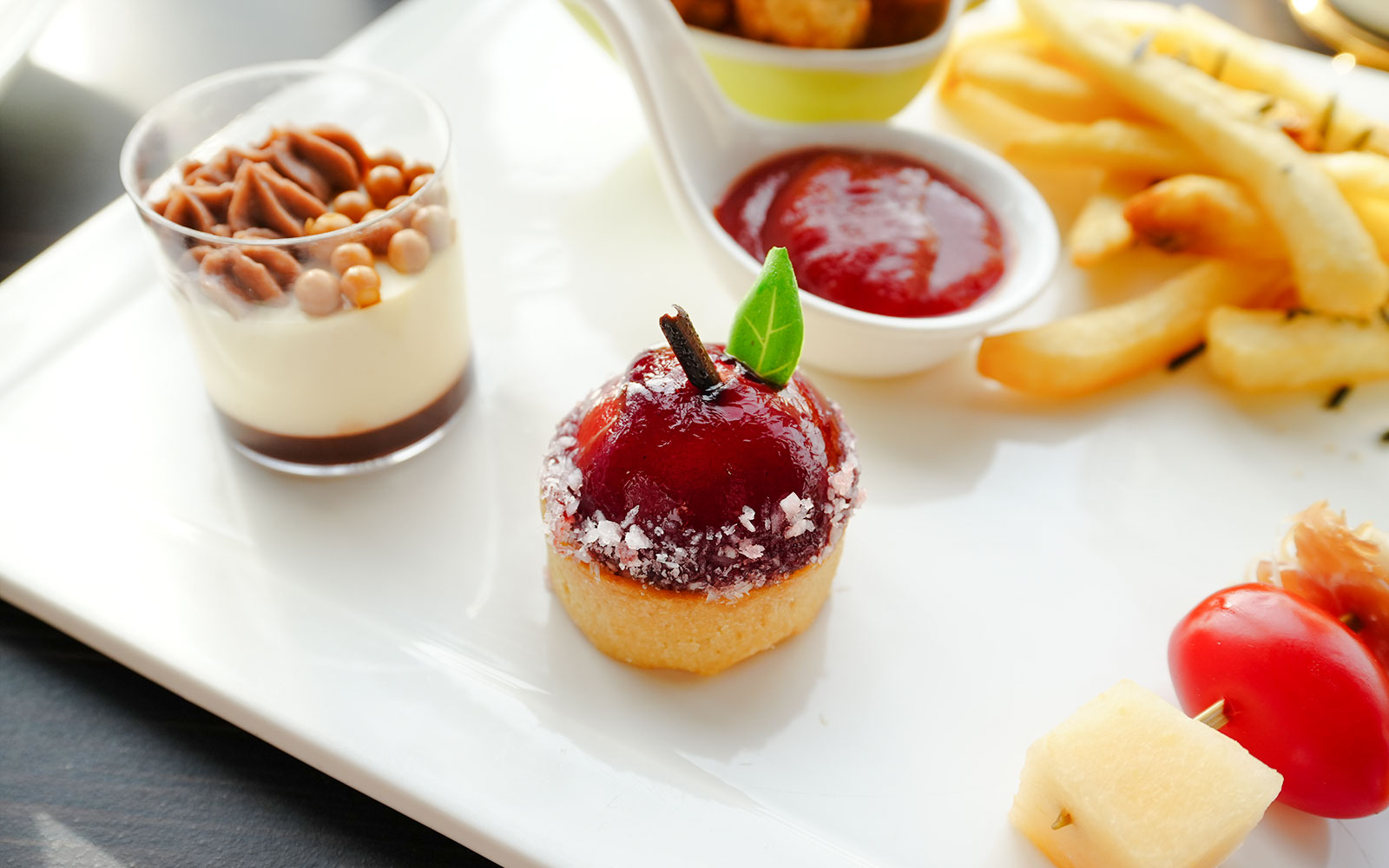 Gourmet dessert platter with pastries and fruit at a Shanghai Tower restaurant.