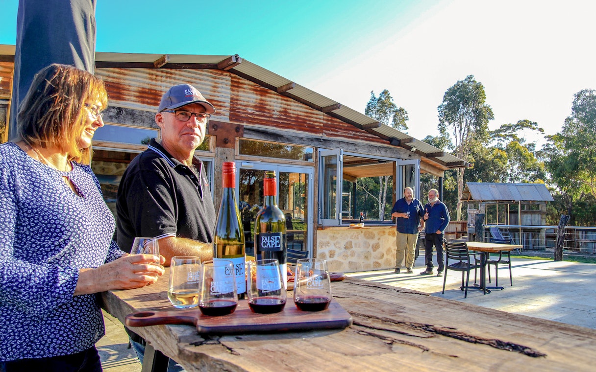 People enjoying wine at a rustic winery in False Cape, Kangaroo Island.