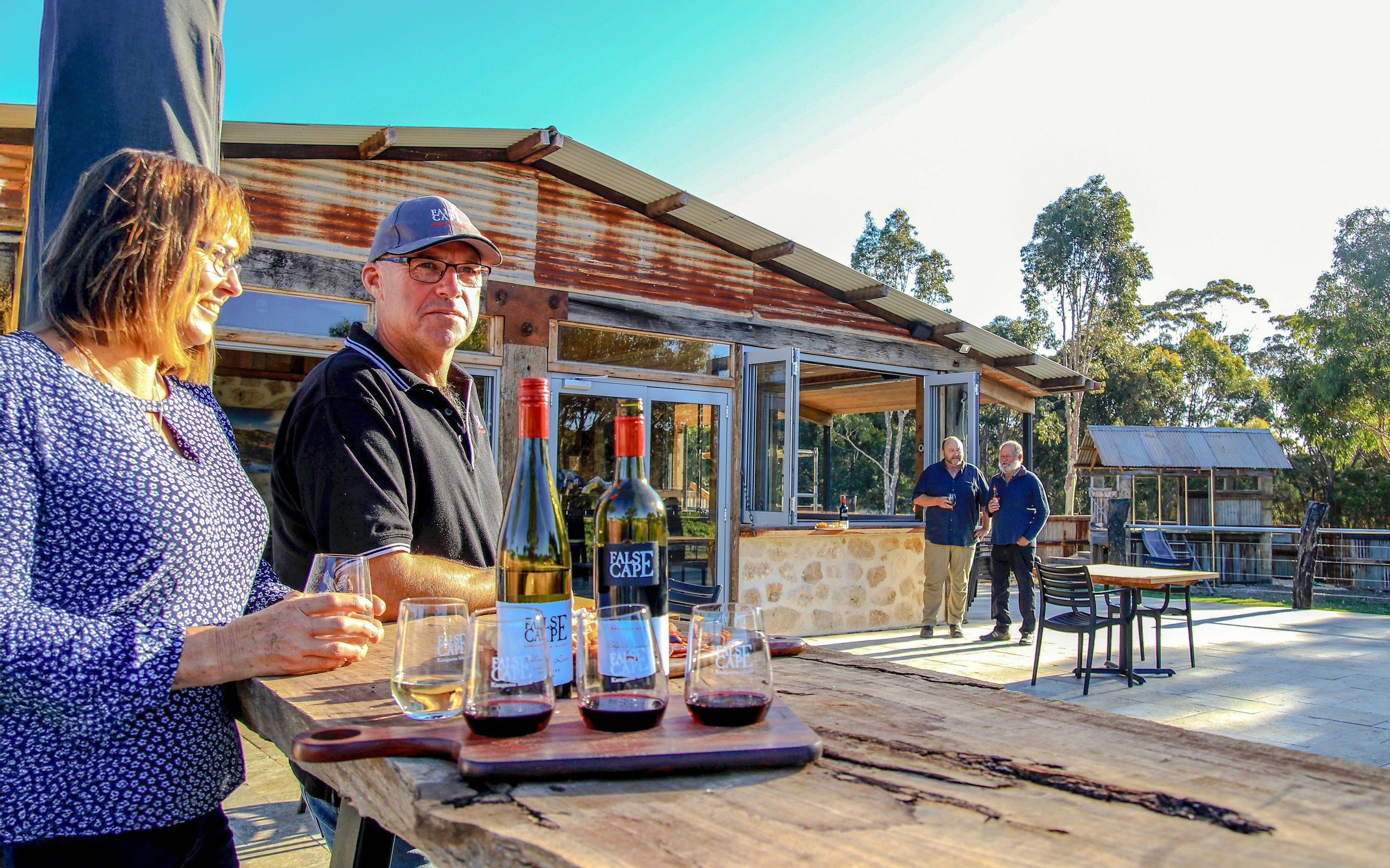 People enjoying wine at a rustic winery in False Cape, Kangaroo Island.