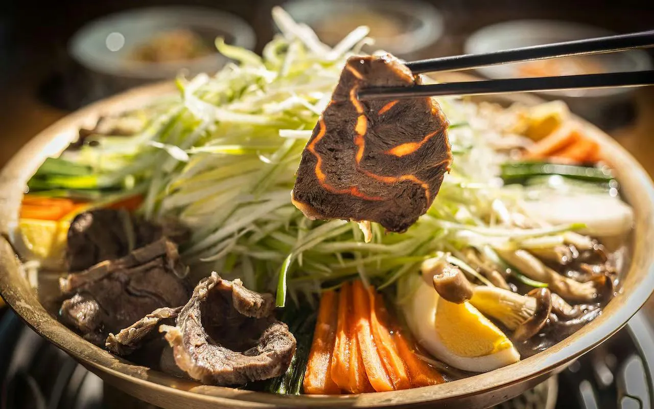 Korean hot pot with beef, vegetables, and egg on DMZ Premium Small Group Tour.