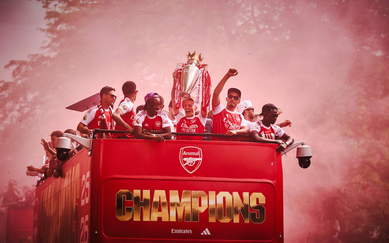 Arsenal players celebrate on an open-top bus during the 2026 Premier League Champions Parade.