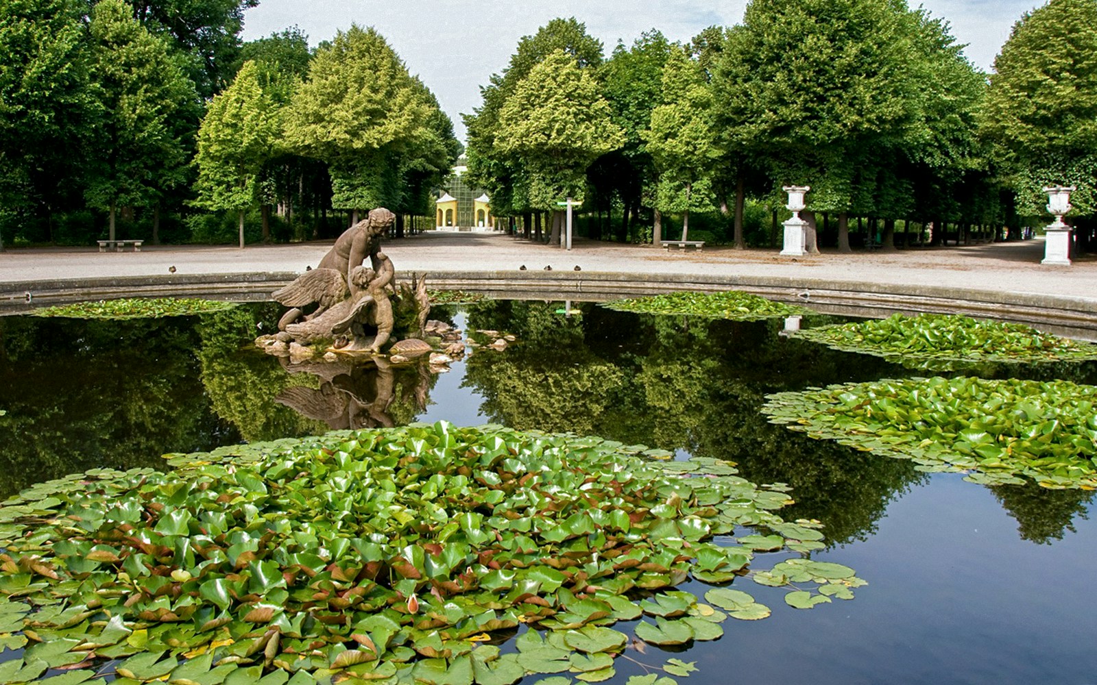 Fountain with statue and lily pads in Schönbrunn Palace Gardens, Vienna.