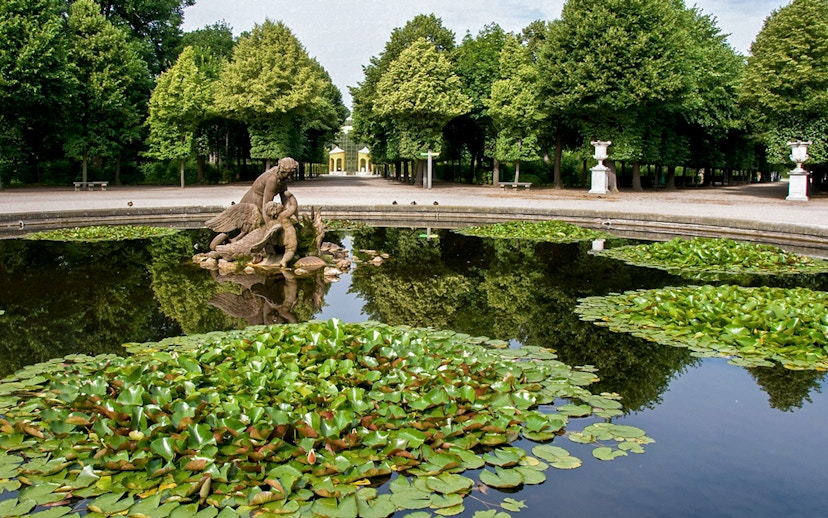 Fountain with statue and lily pads in Schönbrunn Palace Gardens, Vienna.