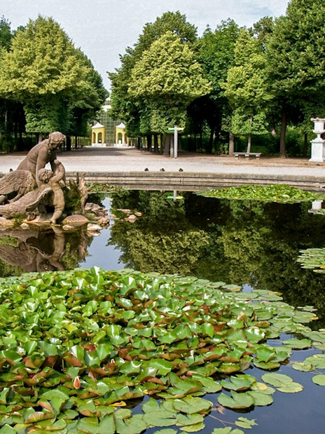 Fountain with statue and lily pads in Schönbrunn Palace Gardens, Vienna.