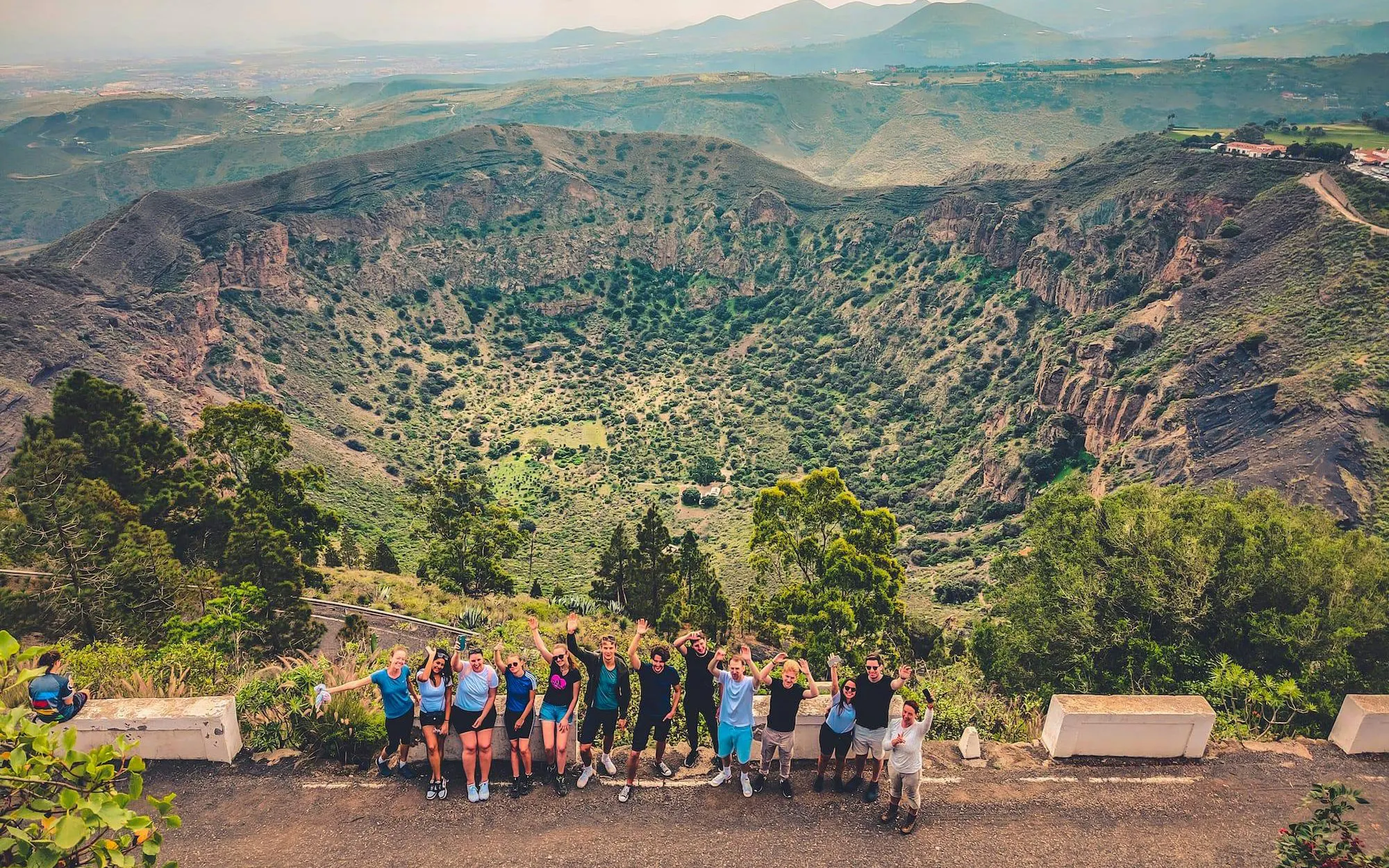 Group enjoying view of volcanic crater in Gran Canaria during sunset tour.