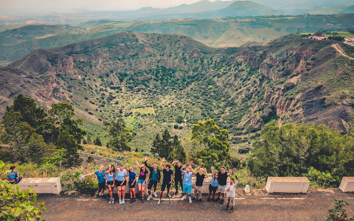 Group enjoying view of volcanic crater in Gran Canaria during sunset tour.