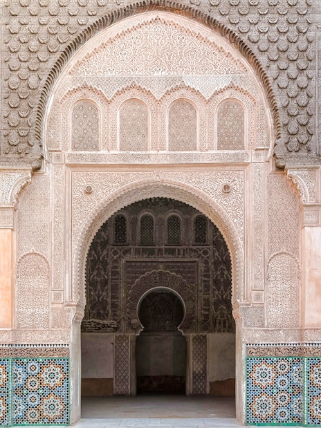 Madrasa Ben Youssef intricate archway and detailed tilework in Marrakech, Morocco.