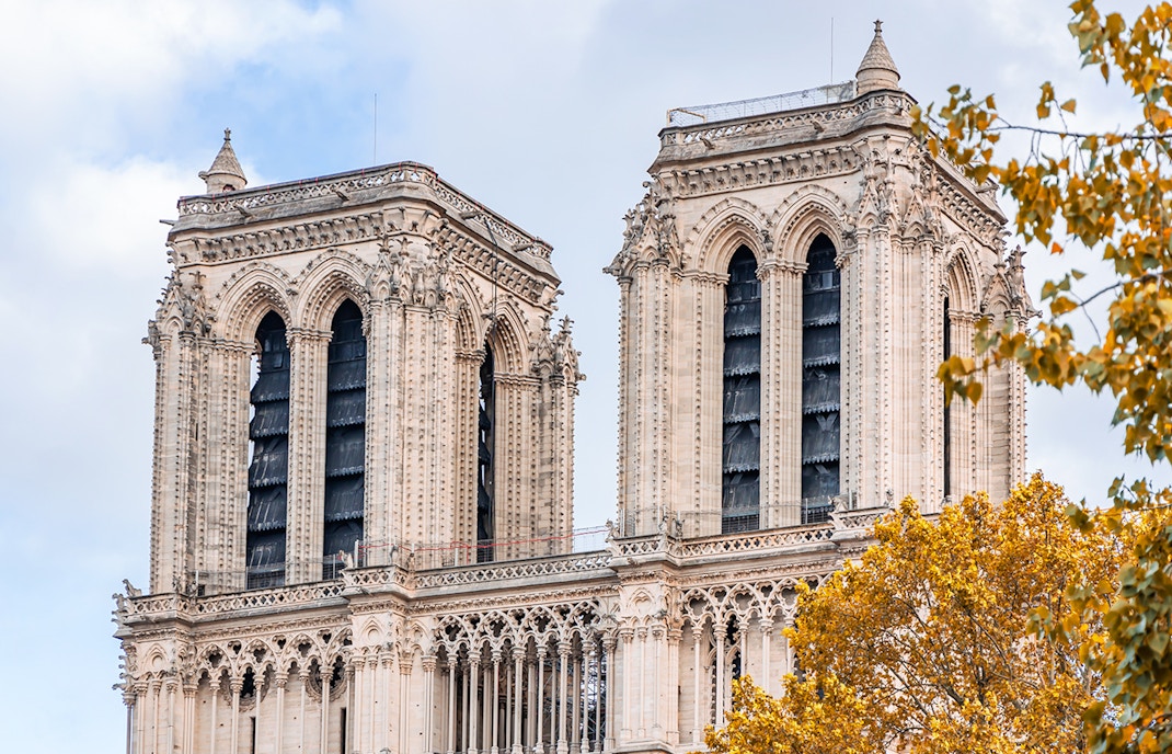 Notre Dame Cathedral bell tower in Paris with cityscape view.