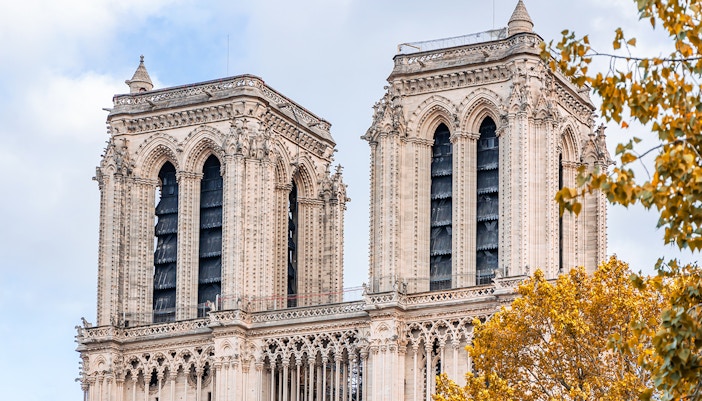 Notre Dame Cathedral bell tower in Paris with cityscape view.