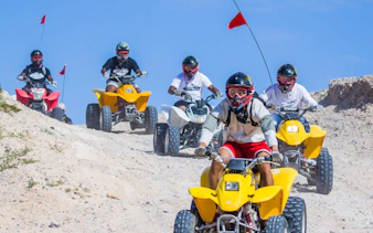ATV riders navigating sand dunes on a Las Vegas guided off-road tour.