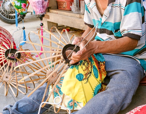 Man crafting traditional Vietnamese lanterns in Hoi An.